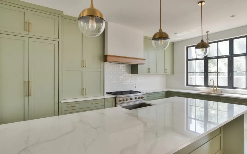 sage green kitchen with pendant lights